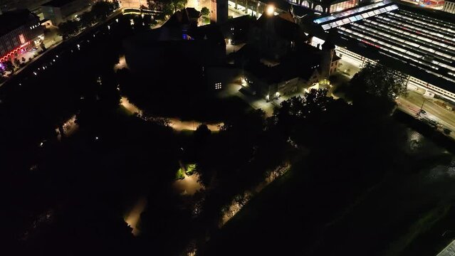 Aerial view of City of Z&uuml;rich by night with National Museum and main railway station on a clear spring evening. Movie shot May 30th, 2023, Zurich, Switzerland.