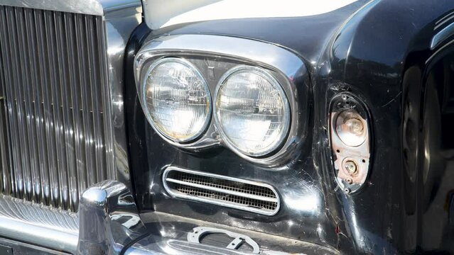 Close up of an old fashioned luxury car headlight.
