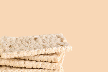 Heap of crispbreads on beige background, copy space.