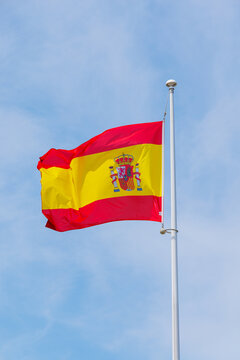 Spain flag waving in the wind on blue sky