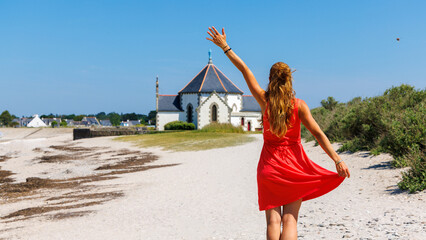 tour tourism in Brittany,  Woman tourist with red dress in Morbihan gulf,  Sarzeau, Penvins in...