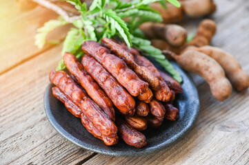 Tamarind peel in plate tropical fruits summer, Tamarind sweet for food fruit ripe tamarinds on plate and white background - top view