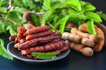 Tamarind peel in plate tropical fruits summer, Tamarind sweet for food fruit ripe tamarinds on plate and white background - top view