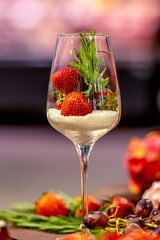 A glass with strawberries on a table