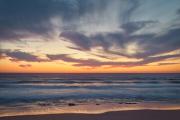 the moment after a beautiful sunset over a beach with pink clouds, Atlantic Ocean, Morocco, Tanger