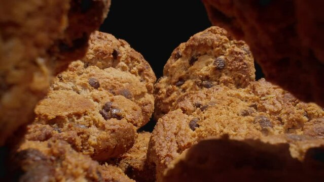 Macro shot of homemade oatmeal cookies. Probe lens. Stack of whole meal cookies. Food concept. Dolly shot. Cookies tunnel. Close-up in 4K, UHD