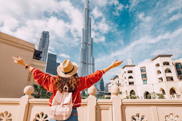 Happy girl arms are outstretched, as she embracing the incredible view before her in Dubai, UAE