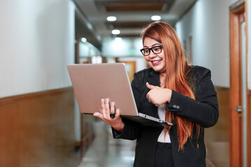 Young indian corporate woman using laptop.