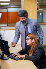 Indian corporate man and woman working together at office