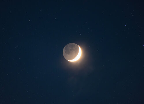 Crescent Moon with Planetshine and stars (collage) in the night sky, photo taken through a telephoto lens