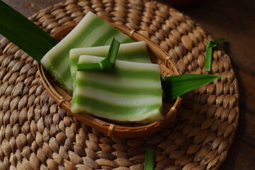 Kue lapis in wooden background 