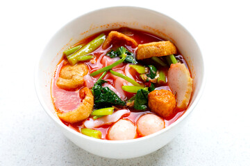 A bowl of pink flat noodles