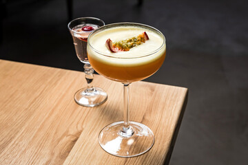 Porn star martini cocktail with passion fruit and vodka at the wooden table at bar or restaurant