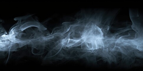 Fototapeta premium A black background with white smoke flowing from the bottom left corner to the center right, creating an abstract and mysterious atmosphere.