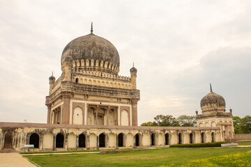 Fototapeta na wymiar View of giant tomb buildings in the vast area of Qutb Shahi Archaeological Park, Hyderabad, India