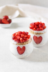 Pudding with strawberries and chia seeds on the white background.