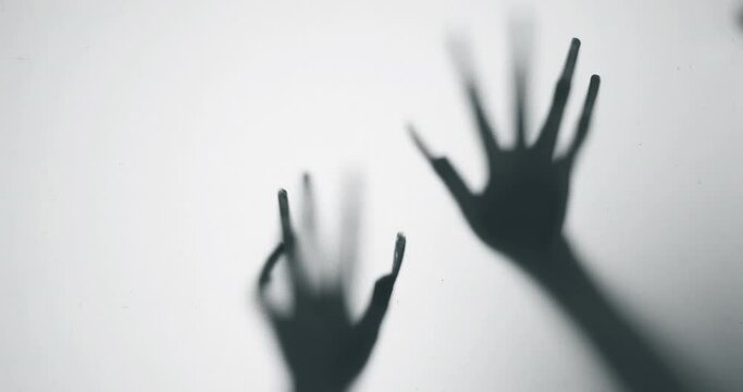 Shadow of a zombie hand on white background
