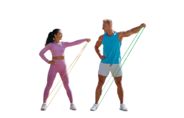 Young adult couple in sportswear training with rubber expander against transparent background. Man training with wife at sunny sunny weekend. Fitness, sport, healthy lifestyle.