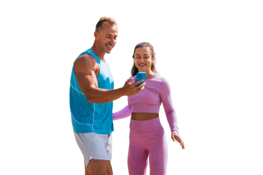 Happy couple in sportswear looking at phones screen against transparent background. Cheerful caucasian man holds phone smiling enjoying video call with children. Sport, fitness, healthy people.