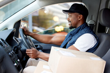 Delivery man, transport and man driving with a smile for shipping or courier service. Happy black...