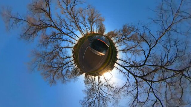 Tiny Planet Slow Motion Rotating Shot of A Car Driving Past A Flying Stork.