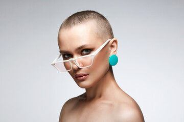 beautiful woman with short haircut wearing glasses. beauty bald woman