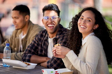 Students, happy and friends eating lunch together on university or college campus for a break as a group. Smile, portrait and group of young people with food, burger or relax in a restaurant