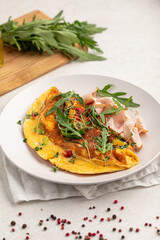 Portion ofgourmet omelette breakfast with smoked chicken