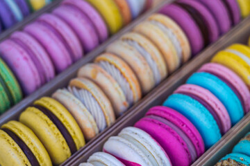 Top view macarons group diagonal. French sweet delicious bakery.  Colorful macaroons display in the restaurant.