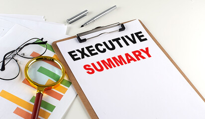 EXECUTIVE SUMMARY text on clipboard with chart on white background, business concept