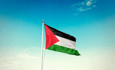 Waving Flag of Palestine in Blue Sky. The symbol of the state on wavy cotton fabric.