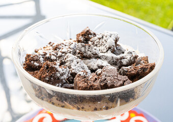 Chocolate Cake Crumbs Sprinkled with Powdered Sugar, Tiramisu in a Small Vase