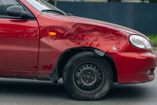 A car accident involving two cars on a city street. Damaged cars. Severe accident. Close-up.