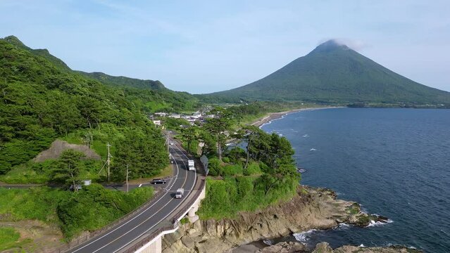 Kagoshima, Japan: Aerial drone footage of the road along the coast of Kyushu with the Kaimon volcano near Kagoshima by the East China sea in Japan. 