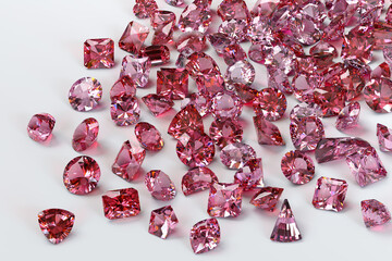 Pink topaz stones scattered on white background.