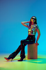 High fashion model, young woman wearing trendy clothes with leather black pants and silver top...