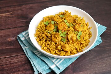 Prawns Biryani or shrimp Pulao. also called jheenga pilaf or jhinga biryani in India. known as Kolambi bhat in Marathi. Garnished with mint leaves, and coriander along with yogurt Raita. Copy space