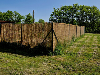 reed mat mats connected with wire mesh. attach to the wire fence and create a visual barrier from...