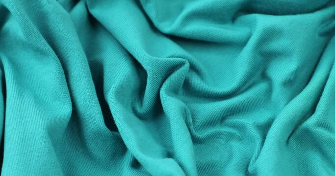 Light blue fabric background. Light blue cloth waves background texture.