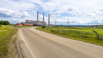 Sundance power plant in rural landscape in summer season with cloud sky background