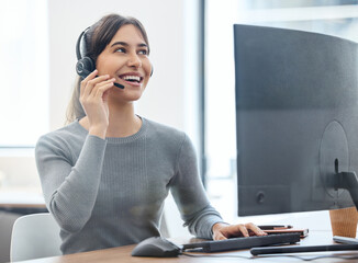 Customer service, woman with headset and on a computer at her desk in a workplace office. Call...