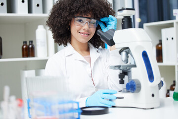 Happy woman, portrait and scientist with microscope for research, testing or experiment in pharmaceutical lab. Female person with smile for scientific search, discover or cure in science laboratory
