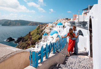 Young traveler couple on honeymoon enjoying the sights of Oia on the island of Santorini in Greece