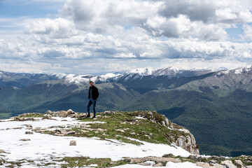 a male photographer takes pictures against the backdrop of mountains and valleys against the backdrop of a beautiful landscape in the mountains of Armenia