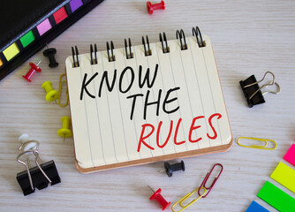 Know the rules symbol. Concept words Know the rules on white notebook. Beautiful wooden background....