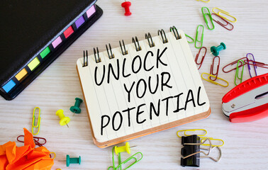 Unlock your Potential symbol. Concept words Unlock your Potential on white notebook. Beautiful wooden background. Business and Unlock your Potential concept. Copy space.