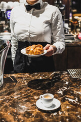 waitress serves a freshly baked swedish cinnamon roll