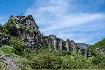ancient temple and the ruins of the fortress wall in the mountains of Armenia