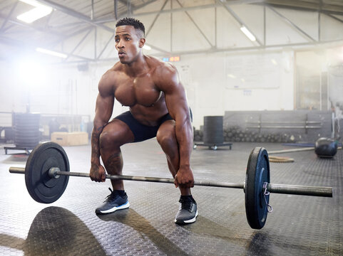 Fitness, muscle and black man with a barbell, training and exercise with strength, wellness and health. Male person, body builder and athlete with gym equipment, strong and workout goal with progress