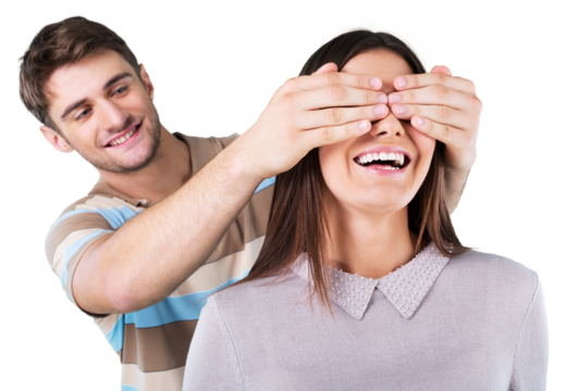 Young boyfriend covering the eyes of his girlfriend for a surprise